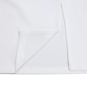 Detail view of white dress showing high-quality slit hemline and double-needle stitching