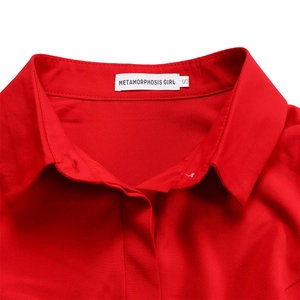 Detail of red shirt dress collar with white brand woven label and neat stitching