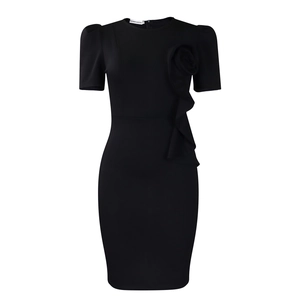 Close-up of elegant black dress with ruffle details and 3D floral decoration on the chest