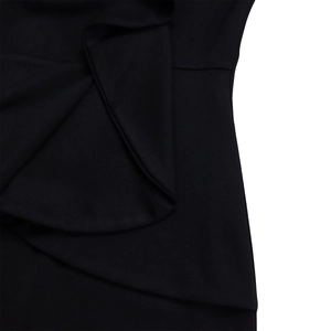 Detailed close-up of ruffle layers and textured black fabric on an African style dress