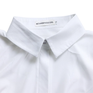 Detailed view of white cotton shirt collar with neat stitching and clear button detail