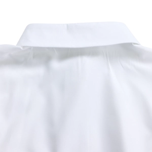 Detailed close-up of the white shirt turn-down collar and shoulder stitching texture