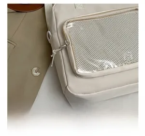Detail shot of precise stitching and mesh pocket on beige nylon crossbody bag