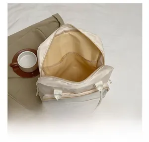 Interior view showing the large capacity and inner pockets of the beige multipurpose bag