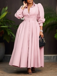 Elegant light pink long-sleeved shirt dress with structured corset waist and A-line skirt