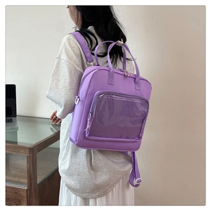 Detail of purple nylon backpack with clear mesh pocket and versatile carry straps