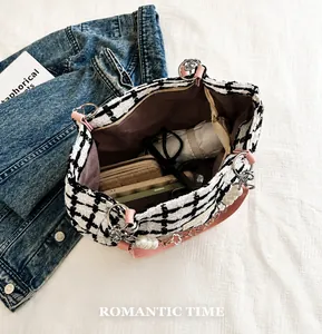Macro view of interior storage capacity showing wallet, phone, and umbrella in tote bag