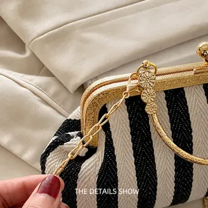 Detailed macro view of baroque engraved gold hardware and black white striped fabric