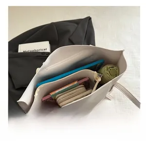 Top view of large cream leather tote showing interior storage for tablet and essentials