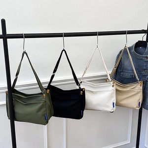 Minimalist high-capacity canvas messenger bags in four colors for daily casual school use