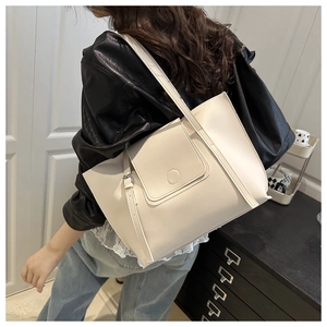 Close-up of beige vintage large-capacity tote bag with metal buckle detail and PU leather