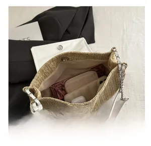 Top view showing spacious interior of the woven straw shoulder bag with chain strap