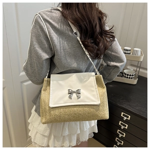 Crossbody bag with woven straw base, white leather flap and silver bow detail