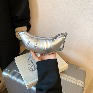 Silver metallic crescent croissant bag with vertical quilting and top zipper closure