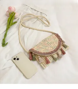 Detail of bohemian saddle bag featuring colorful woven patterns and vibrant fringe tassels
