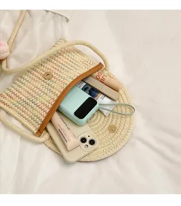 Detail view of woven saddle bag with rainbow embroidery showing spacious interior