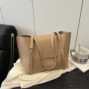 Minimalist beige tote bag in synthetic leather on a modern home interior setting