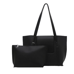 Minimalist black leather tote bag with matching pouch for daily work and commuting