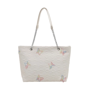 White tote bag featuring colorful butterfly embroidery and silver chain straps