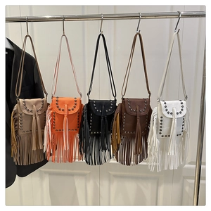 Row of five bohemian fringe crossbody bags with rivet studs in assorted colors
