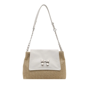 Straw shoulder bag with white leather flap and silver bow lock on white background