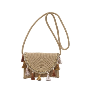 Ethnic woven straw crossbody bag with colorful tassels and soft cream shoulder strap