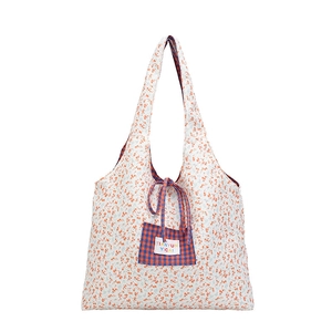 Floral canvas tote bag with orange flower print and blue plaid front drawstring pocket