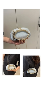 Detail of light blue shell bag with oval gold handle and elegant metal chain strap