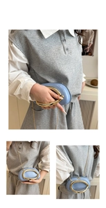 Detailed close-up of light blue semi-round bag with large gold C-shaped metal handle