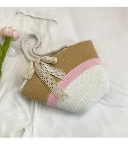 Top view of woven tote bag with tricolor stripes, lace bow detail and rope handles