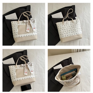Quilted tote bag showing spacious interior with multiple items and bicolor design details