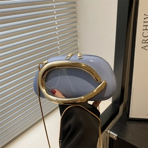 Minimalist light blue patent leather clutch bag with large gold metal ring handle
