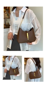 Detail of coffee brown leather hobo bag with gold metal buckle and chain strap on model