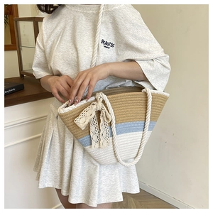 Close-up of tricolor woven tote bag with dense rope texture and white lace bow detail