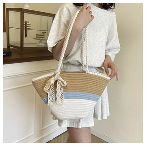 Close-up of contrast woven tote bag with lace bow decoration in a coffee shop setting