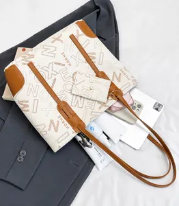 Detail showing high-capacity printed tote bag with matching pouch and work essentials