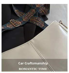 Detail of high-density stitching craft and retro patterned strap on cream leather bag