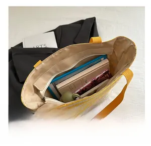 Interior view of spacious straw tote bag showing compartments and large storage capacity