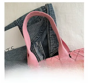 Detail of pink corduroy tote bag featuring widened fabric handles and zipper closure