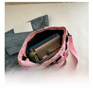 Pink corduroy tote bag showing large interior capacity for tablet, umbrella and notebooks