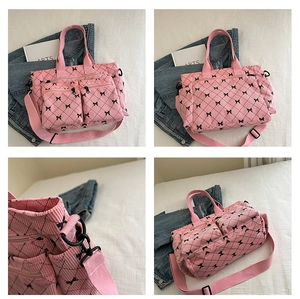 Pink corduroy tote bag detail with black bow print and diamond quilted texture