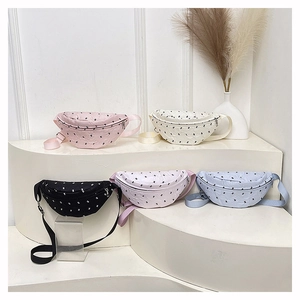 Detailed display of quilted bow chest bags in five colors on a modern white display stand