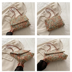 Close-up of floral chain bag showing retro jacquard fabric and metal chain strap details