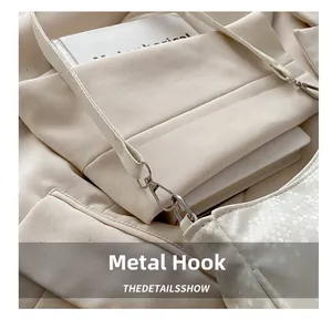 Detailed macro view of white crocodile pattern leather texture and silver metal hook