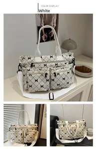 Detail of white corduroy tote bag with black bow lattice pattern and multiple zip pockets