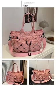 Detail of pink corduroy tote bag featuring bow patterns and multiple zip pockets