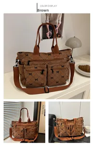 Brown corduroy tote bag with black bow patterns and functional front zipper pockets