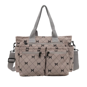 Khaki corduroy bow tote bag with black lattice pattern and multiple zipper pockets
