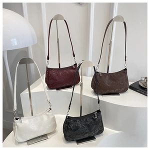 Macro detail of snakeskin pattern shoulder bags in four colors with sleek metal zippers