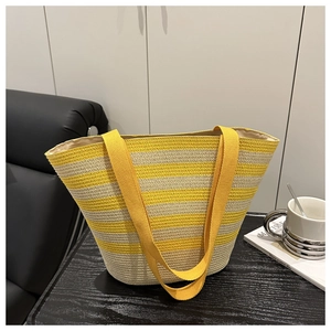 Detail of yellow and beige striped woven tote bag with durable fabric handles